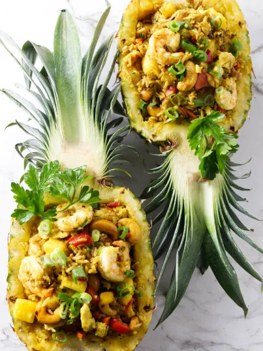 Pineapple fried rice in pineapple bowls.
