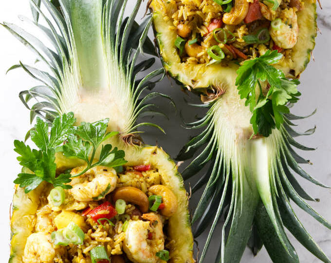 Pineapple fried rice in pineapple bowls.