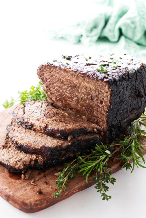 A cooked sauerbraten roast on a cutting board.