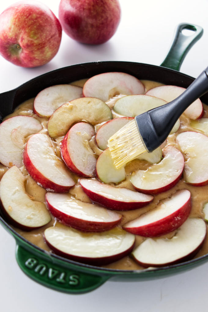 Brushing melted butter on apple slices