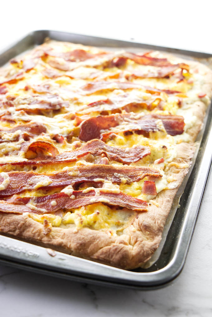 A bacon and egg pizza baked in a sheet pan.