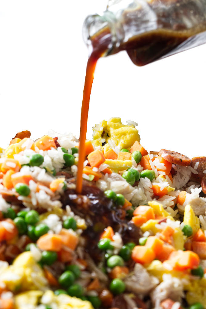 Fried rice sauce being poured over fried rice.