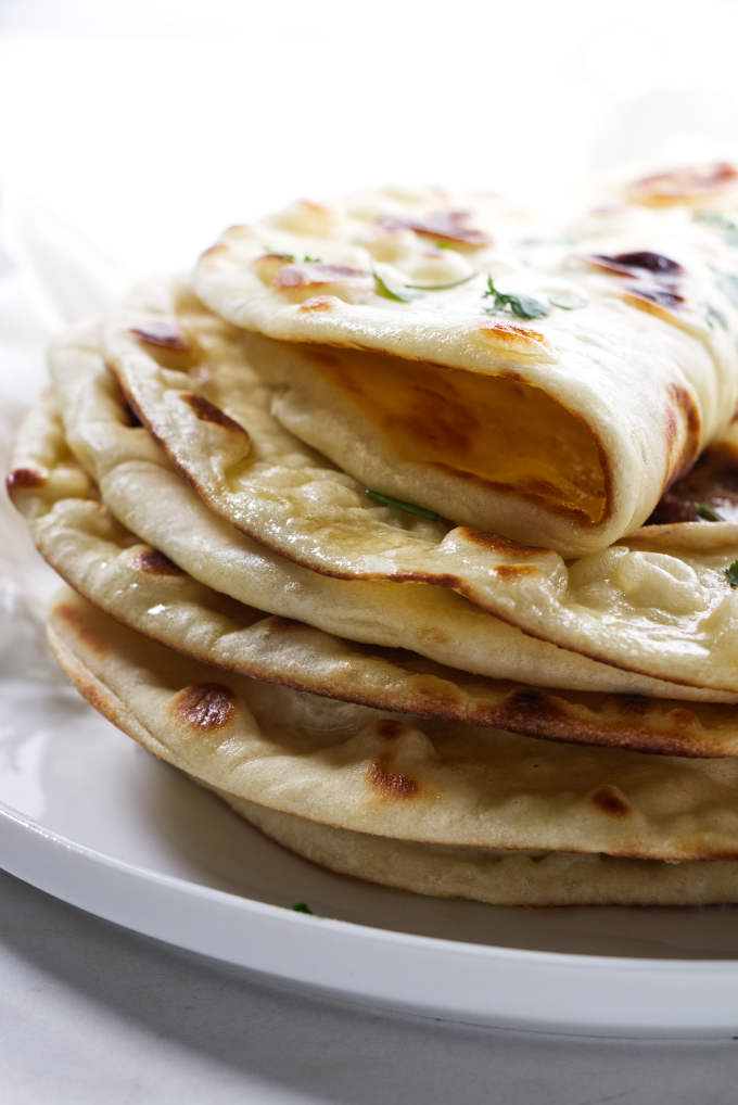 A stack of flatbread on a plate.