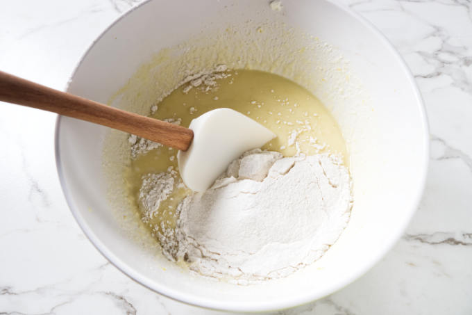 Mixing flour into pancake batter.