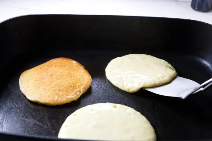 Flipping a pancake over with a spatula.