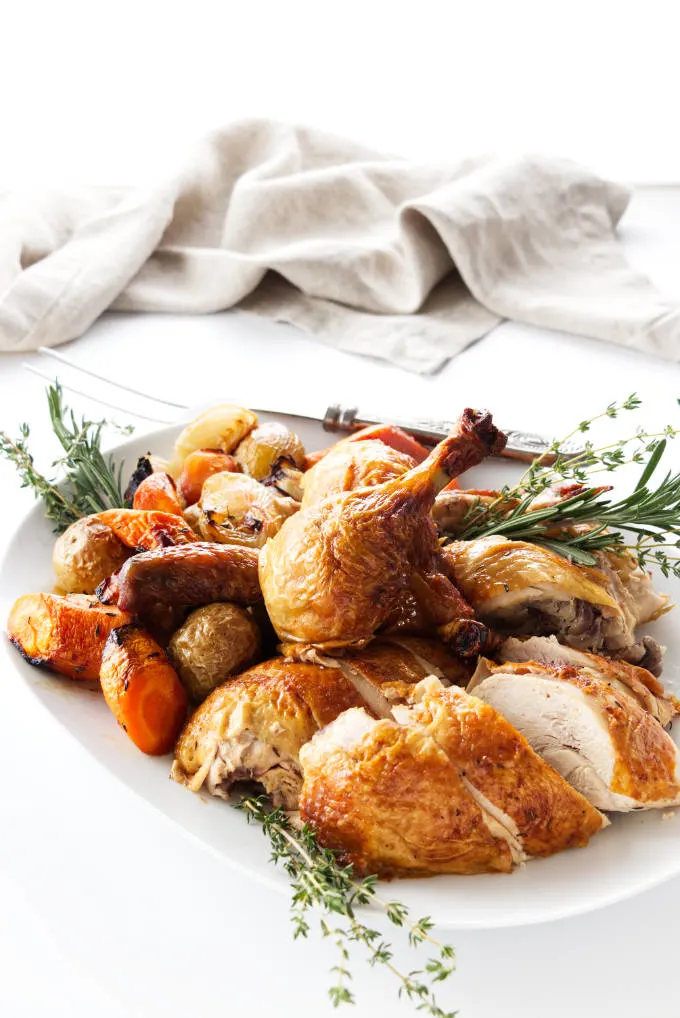 Carved roasted chicken and vegetables on a platter