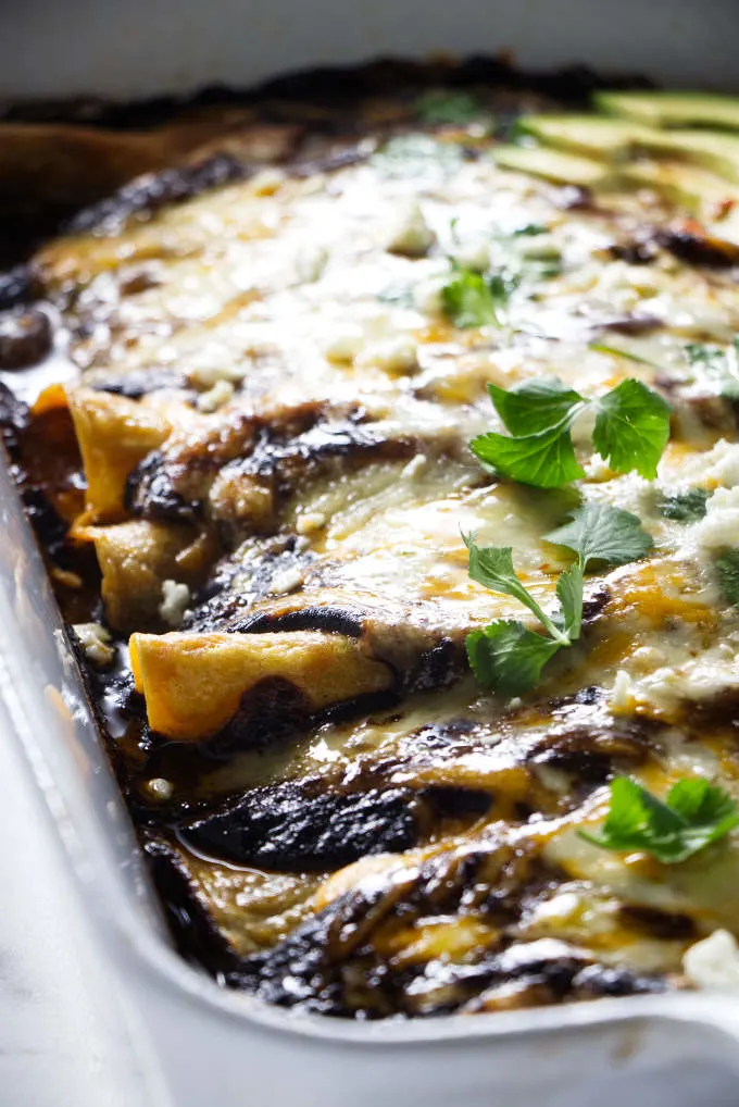 A baking dish filled with mole enchiladas.