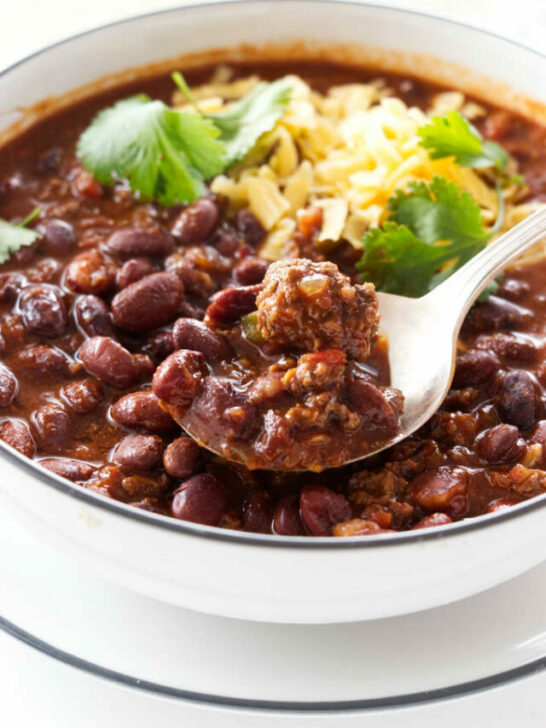 A bowl and spoon with chili beans.