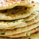 A stack of naan bread made with einkorn flour.