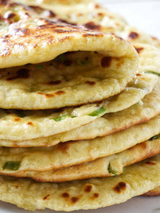 A stack of naan bread made with einkorn flour.