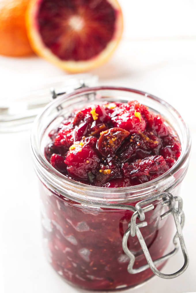 A jar filled with cranberry chutney.