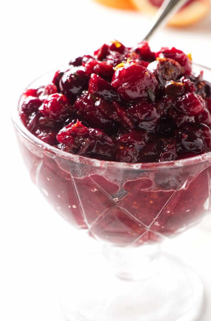 A serving dish filled with cranberry chutney.