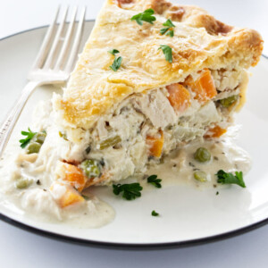 A large slice of turkey pot pie with white wine gravy.