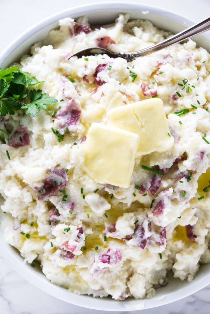 Butter melting on top of mashed red potatoes.