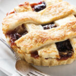 A dried cherry tart on a dessert plate.