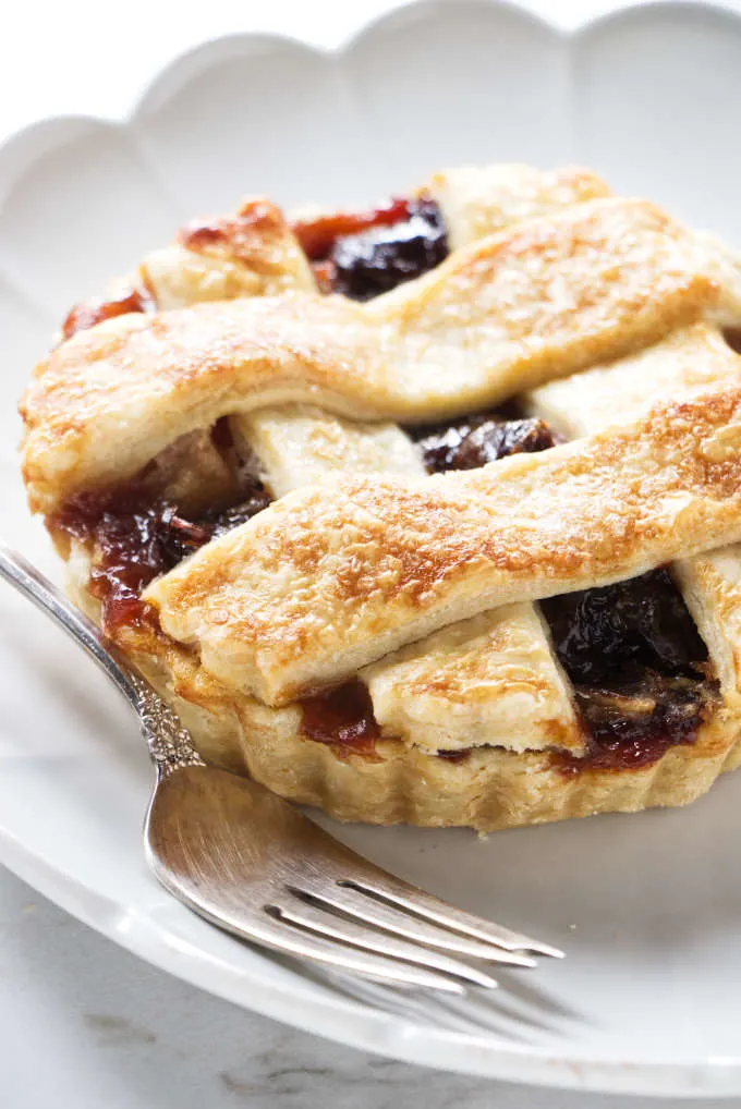 A dried cherry tart on a dessert plate.