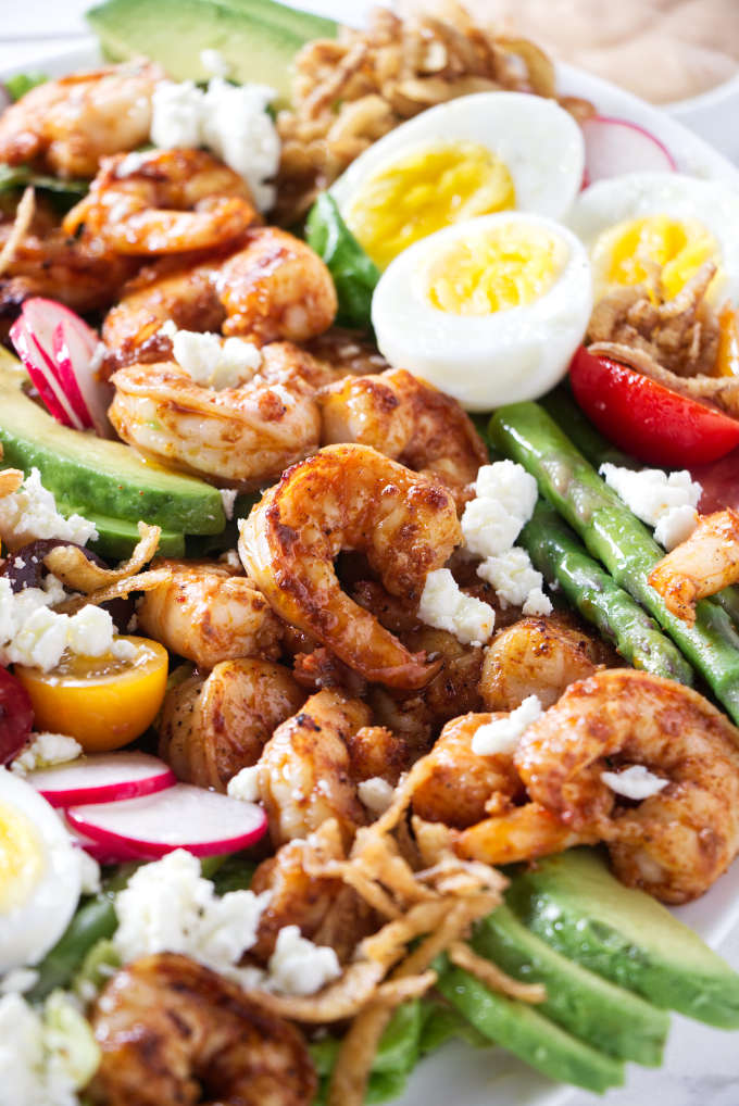 A serving dish filled with shrimp Louie salad.