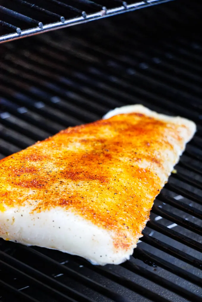 A sea bass fillet on a Traeger grill.