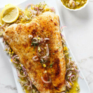 A smoked sea bass fillet on a serving dish.