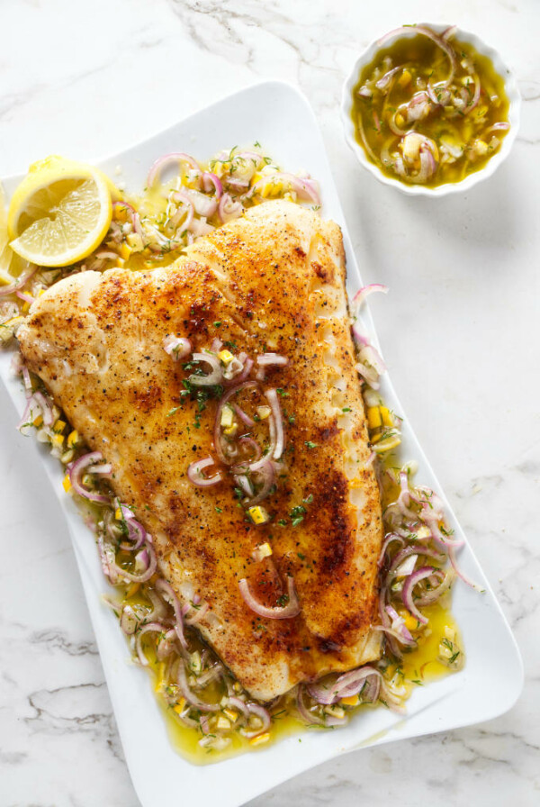 A smoked sea bass fillet on a serving dish.