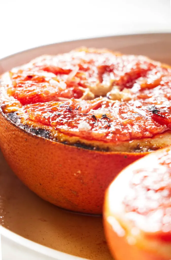 A halved grapefruit in a baking dish.