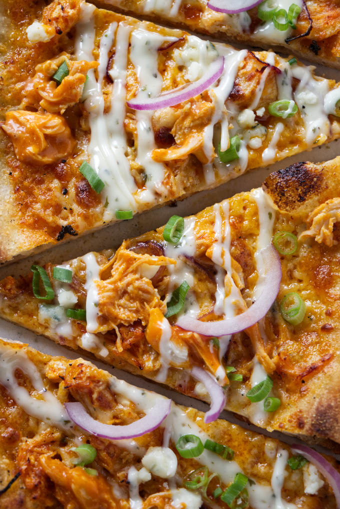 A closeup photo of the toppings on a buffalo chicken pizza.