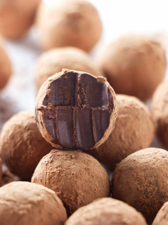 A French chocolate truffle with bite marks.