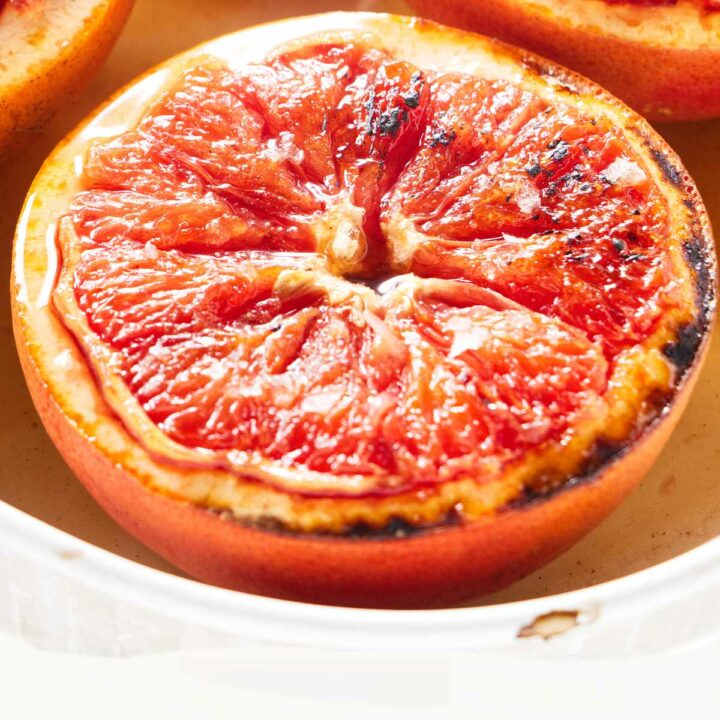 A grapefruit half with char marks from the oven.