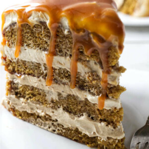 Caramel sauce dripping off a slice of pumpkin layer cake.