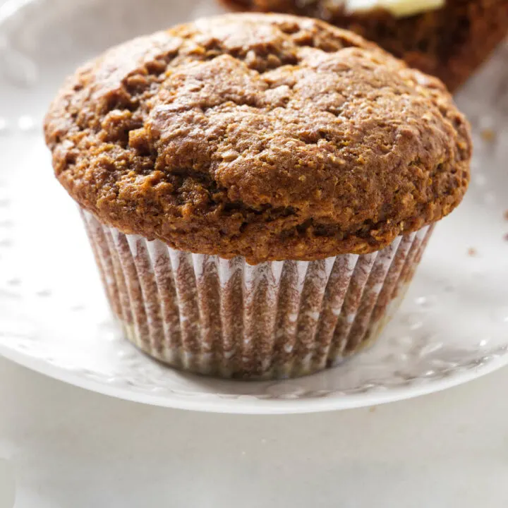 A bran muffin on a plate.