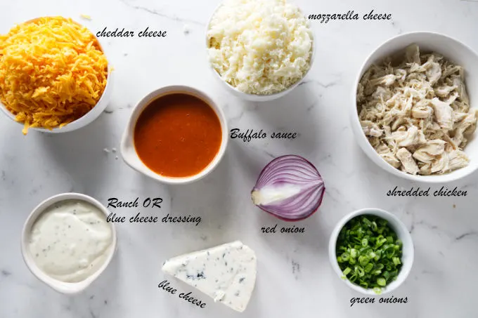 Ingredients used to make buffalo chicken pizza.