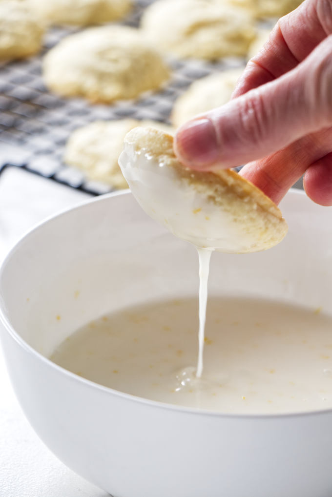 Dipping a cookie in lemon icing.