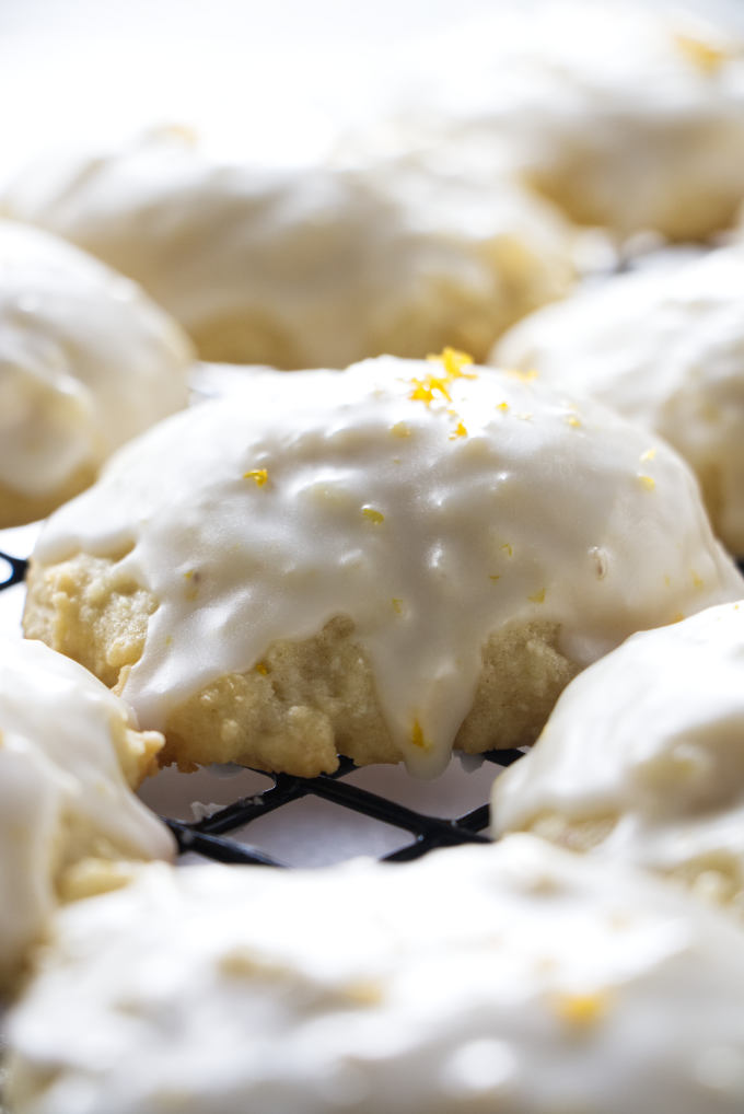 Iced ricotta cookies with lemon zest on top of the icing.