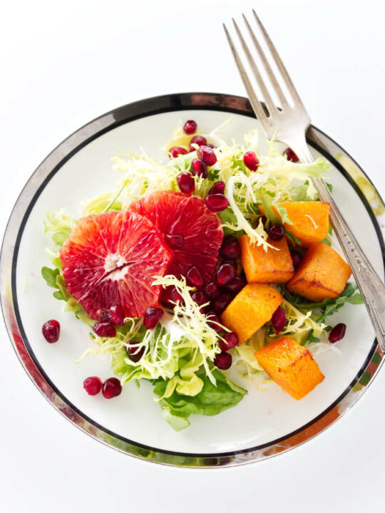 overview of mixed green salad with blood orange