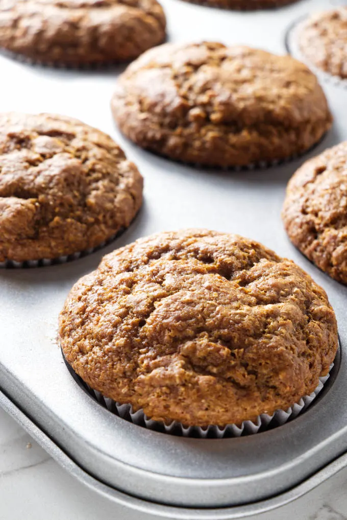 Fresh bran muffins in a muffin tin.