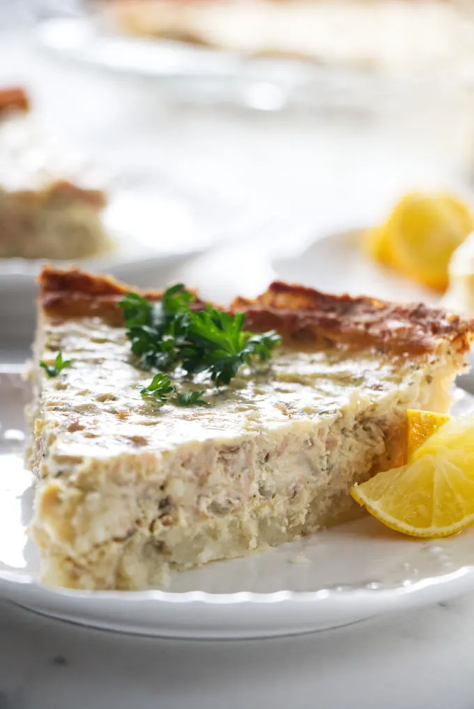 A slice of salmon quiche with a potato crust.