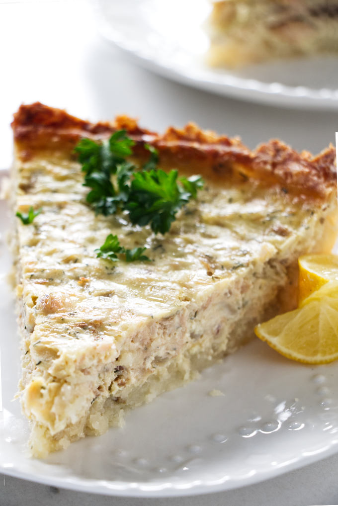 A slice of a potato crusted salmon quiche.