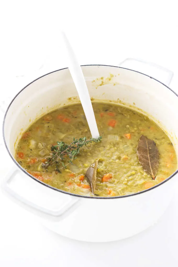 Soup pot with split peas, veggies and herbs