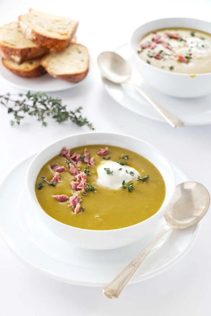 two servings of smoky split pea soup, bread in the background