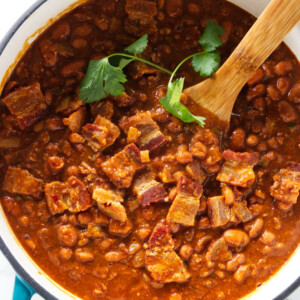 A Dutch oven filled with charro beans.