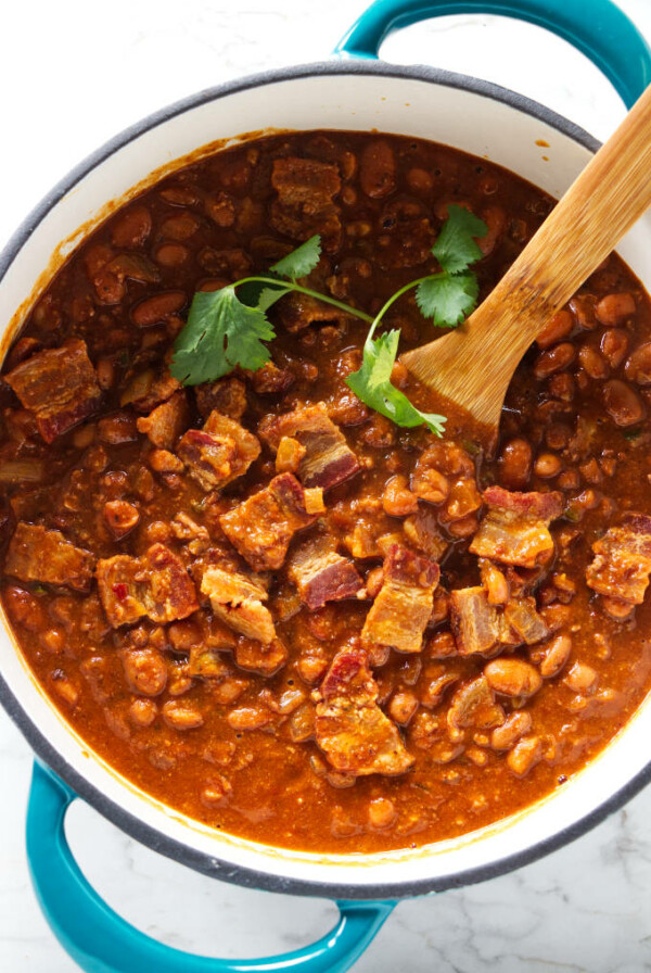 A Dutch oven filled with charro beans.