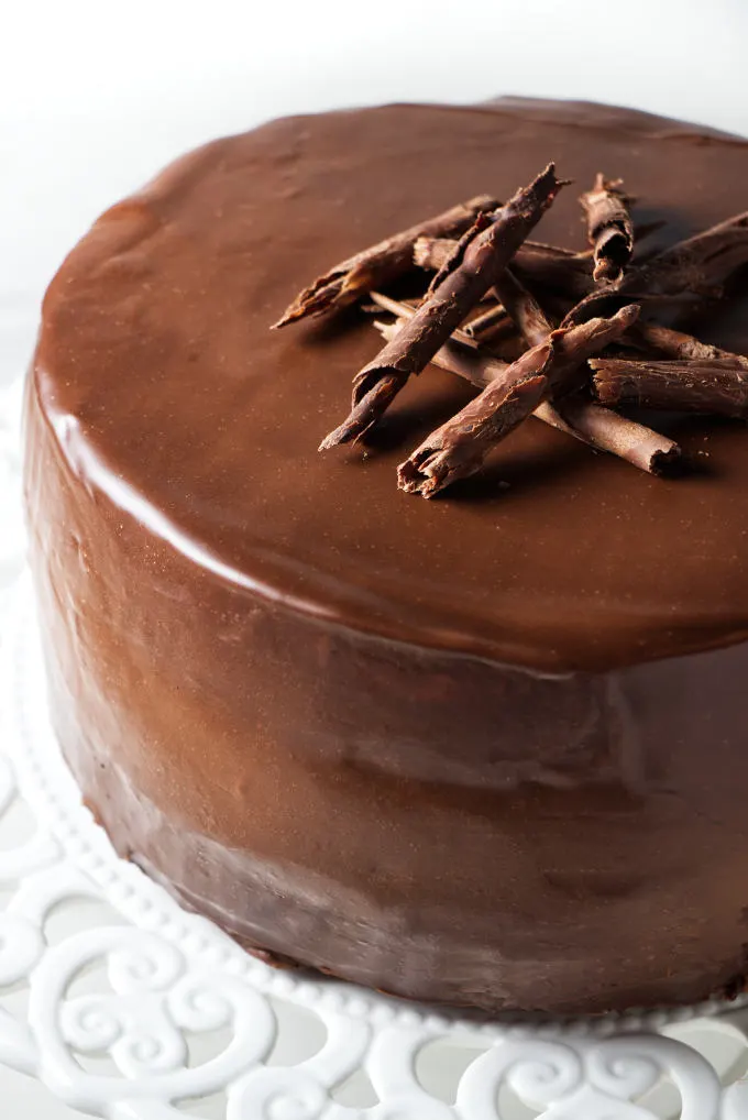 A chocolate cake covered in chocolate ganache.