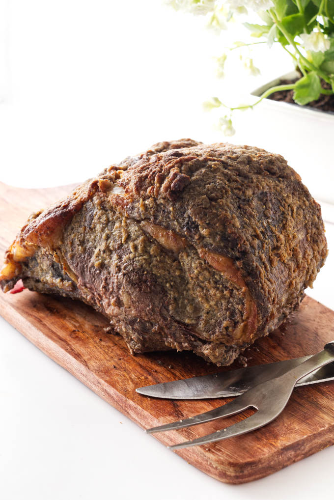 Horseradish Crusted Prime Rib Roast on cutting board with knife and fork