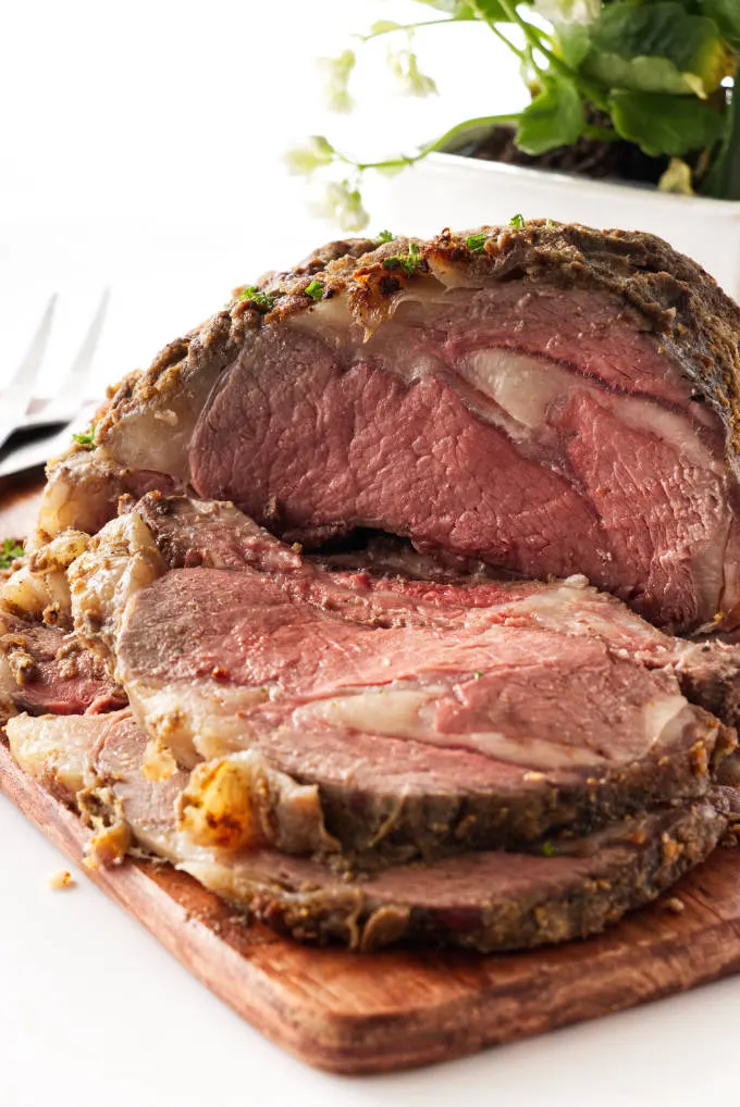 Sliced prime rib roast on cutting board