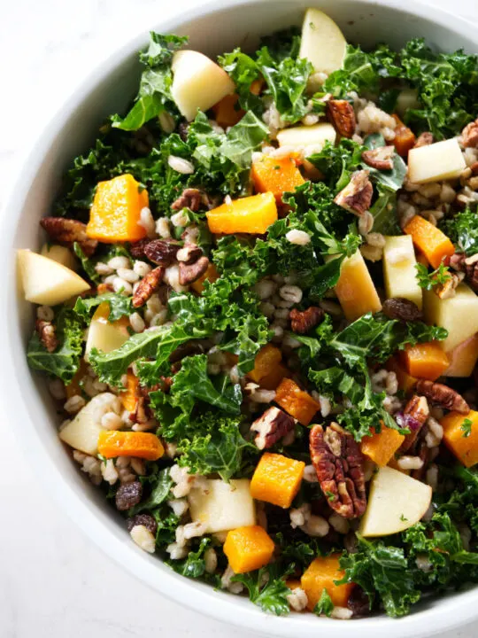 Kale and squash salad mixed with apples and barley.