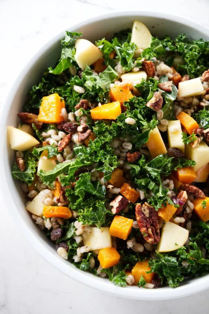 Kale and squash salad mixed with apples and barley.