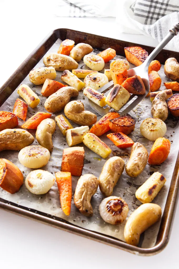 Freshly cooked root vegetables on a roasting tray.