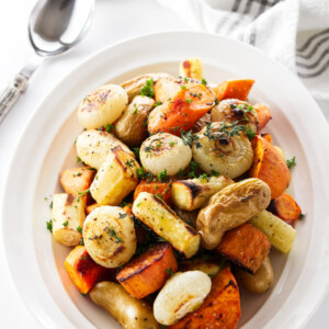 Roasted root vegetables with char marks from the oven.