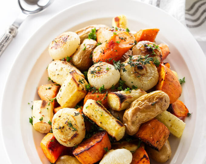 Roasted root vegetables with char marks from the oven.