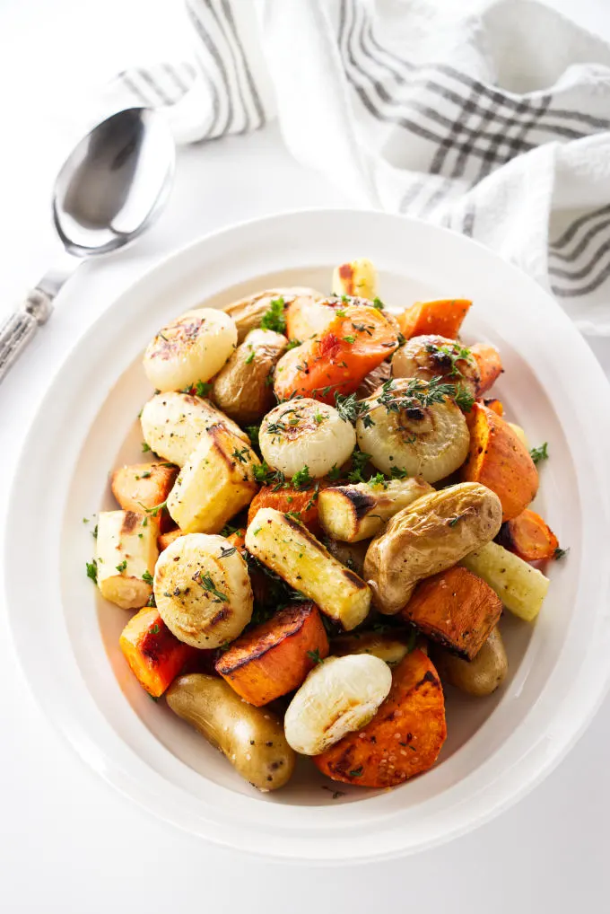 Roasted root vegetables with char marks from the oven.